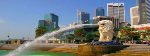 Modern city skyline with Merlion fountain in Singapore, showcasing connectivity.